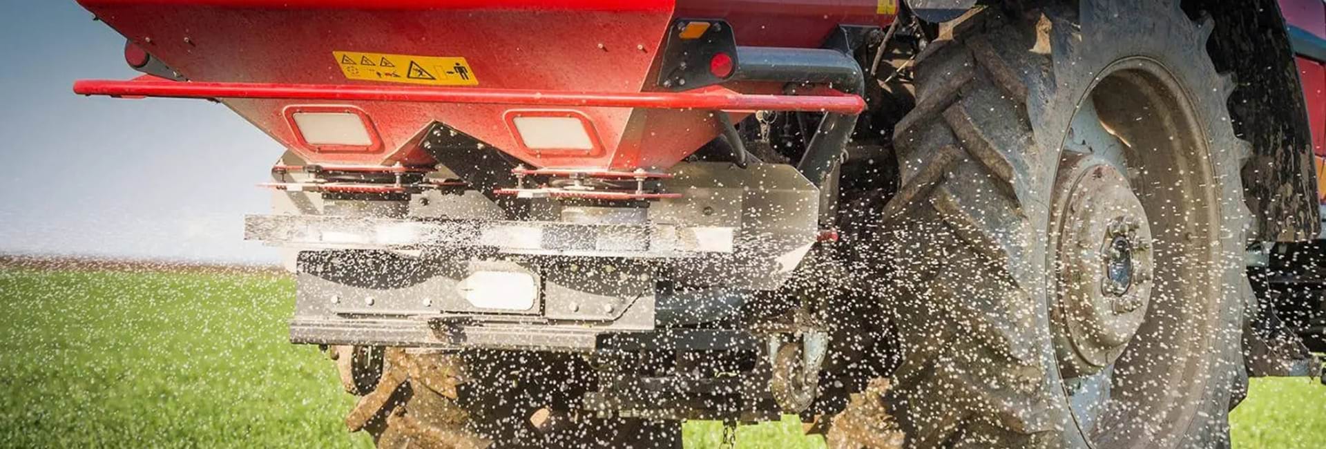 Tractor distributing fertilizer