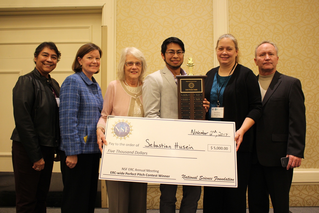 Sebastian Husein, winner of the 2017 ERC-wide Perfect Pitch contest, with the $5000 first-prize check and Lynn Preston trophy, presented by Ms. Preston with QESST Center Director Christiana Honsberg.