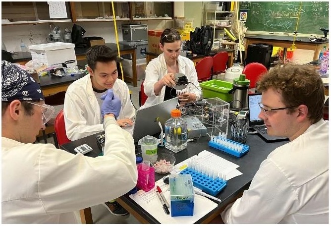 Senior design team members calibrate their improved device for freezing and preserving aquatic reproductive cells 