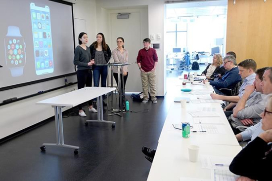 Students present their concept for PanicAway, an iPhone app that can detect a panic attack and offer real-time coping mechanisms, to a panel of industry judges.